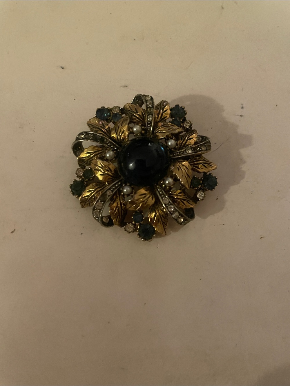 Vintage-Inspired Gold Floral Brooch with Deep Blue Cabochon